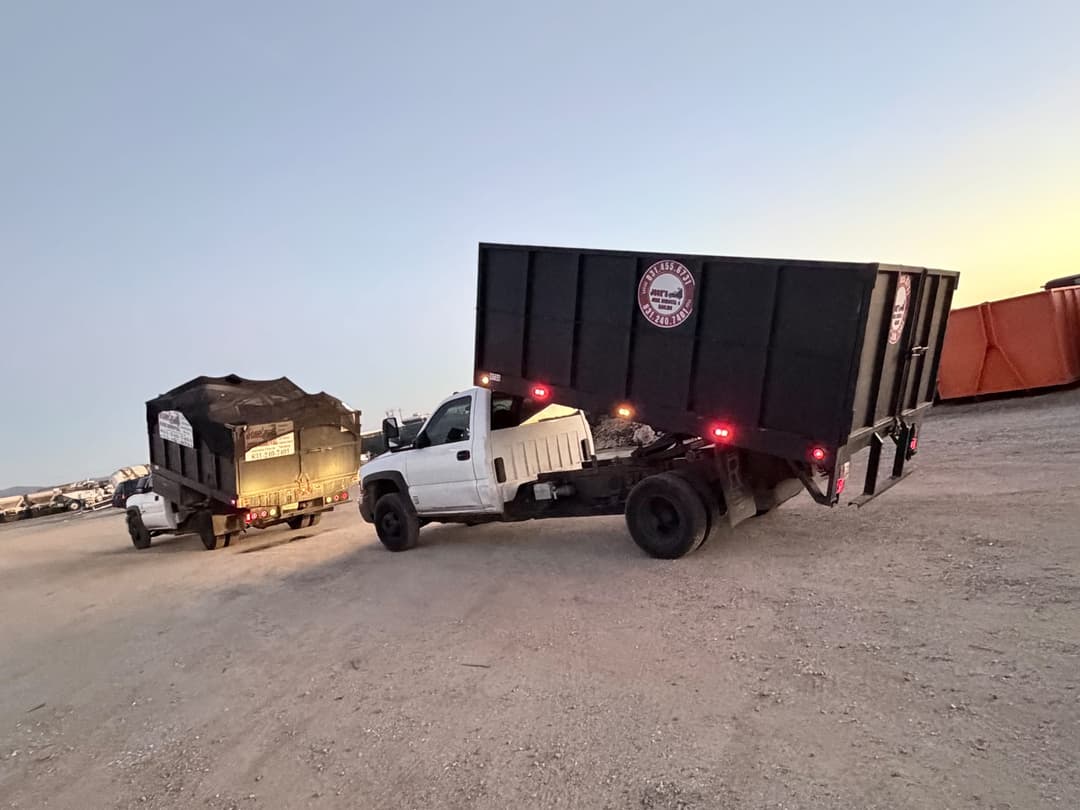 Heavy-duty junk removal truck transporting large commercial debris containers